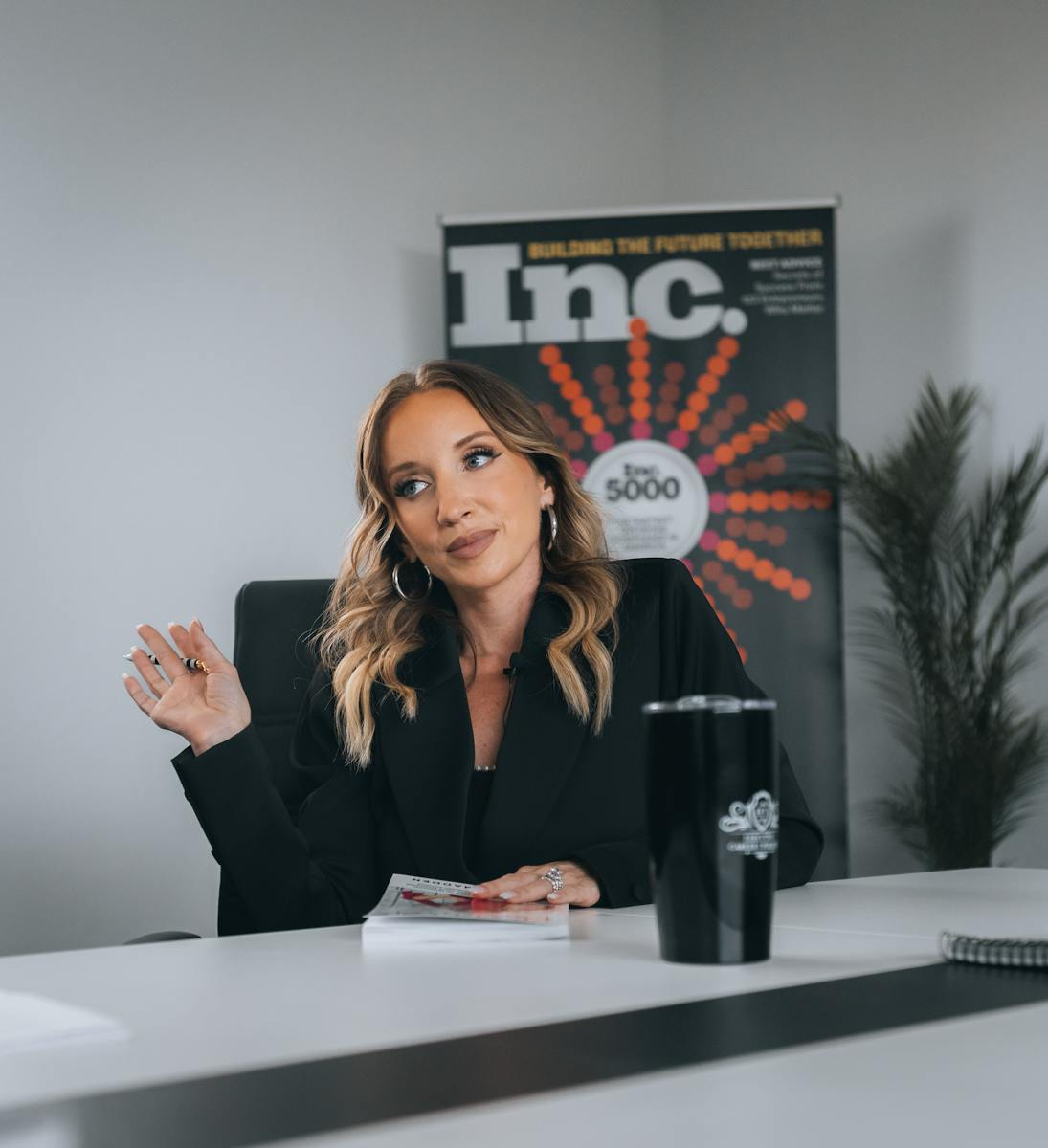 A confident businesswoman in a modern office setting with a focus on leadership and professional growth.